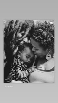 a black and white photo of a family with dreadlocks