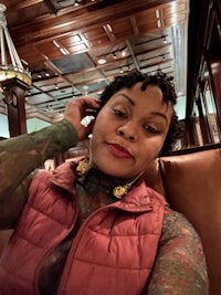 a woman with tattoos sitting in a chair