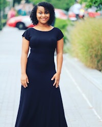 a woman wearing a black maxi dress
